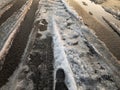 Tire tracks on a snow covered asphalt road Royalty Free Stock Photo