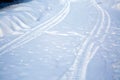 Tire tracks on a snowy road. Winter road not cleared of snow. Hard to drive. Village country road Royalty Free Stock Photo