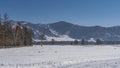 Tire tracks are visible on the trampled road in the snow. Royalty Free Stock Photo