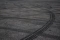 Tire tracks. wheel track on asphalt road. asphalt with traces of car wheels. Traces of braking from rubber tyres on cement. Abstra Royalty Free Stock Photo