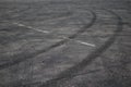 Tire tracks. wheel track on asphalt road. asphalt with traces of car wheels. Traces of braking from rubber tyres on cement. Abstra Royalty Free Stock Photo