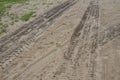 Tire or tractor marks in brown dirt or sand