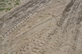 Tire or tractor marks in brown dirt or sand