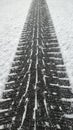 Tire tread footprint on white snow of winter road