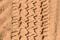 Tire tread footprints of a dump truck on the sand. Construction site. Pattern. Brown abstract background. Car wheel Royalty Free Stock Photo