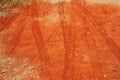 Tire tread marks on dry red soil road Royalty Free Stock Photo