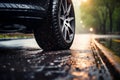 Tire on a wet road. Summer theme with copy space. Stormy weather driving safety concept. Generative Ai Royalty Free Stock Photo