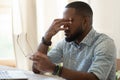 Tired african american businessman holding glasses feeling eye strain Royalty Free Stock Photo