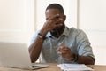 Exhausted biracial man take off glasses suffering from headache Royalty Free Stock Photo