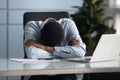 Tired african American man fall asleep at office desk