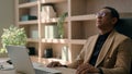 Tired African American man thoughtful male employer take break after laptop work at office concerned businessman worried Royalty Free Stock Photo