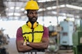 tired African American mechanical engineer worried standing by in factory. black labor worker man bored work in warehouse . male Royalty Free Stock Photo