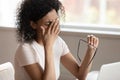 Tired african american millennnial woman dropping eyeglasses, rubbing eyes. Royalty Free Stock Photo