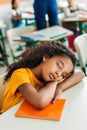 tired african american schoolgirl sleeping on desk Royalty Free Stock Photo