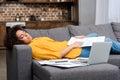 tired african american woman sleeping on couch after work Royalty Free Stock Photo
