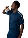 Tired african athlete drinking water Royalty Free Stock Photo