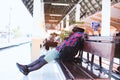 Tired african traveler sleeping on bench at train station