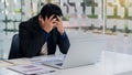 Tired and anxious business people in office work put their hands on the table with graphs and laptops