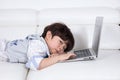 Tired Asian Chinese little boy playing laptop on the couch Royalty Free Stock Photo