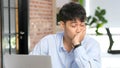 Tired asian man sleeping at office desk. Young businessman overworked and fell asleep, Creative casual man sleeping at his working