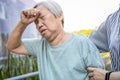 Tired asian senior woman has a bad headache suffer from migraine,high blood pressure,sick elderly people touching aching head in Royalty Free Stock Photo