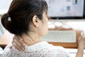 Tired asian woman with back neck and shoulders pain on muscle,stiff neck,symptom sore,painful while working,sick people have Royalty Free Stock Photo