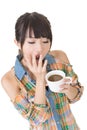 Tired asian woman with cup of coffee