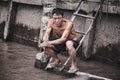 A tired Asian worker washes his hands in the river.