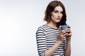 Tired auburn-haired woman drinking coffee