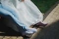 Tired barefoot wedding couple is sitting