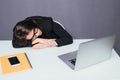 Tired beautiful business woman sleeping on her desk in her office. Royalty Free Stock Photo