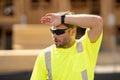 Tired bilder man in hardhat. Construction man with helmet. Industry worker at construction building. Engineer man Royalty Free Stock Photo