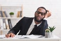 Tired black businessman in glasses having nap in his office Royalty Free Stock Photo