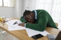 Tired Black Businessman Sleeping On Desk Among Papers In Office Royalty Free Stock Photo
