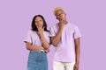 Tired black couple yawning with hands near mouths, feeling sleepy on lilac studio background