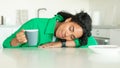 Tired Black Woman Sleeping Holding Coffee Having Breakfast In Kitchen Royalty Free Stock Photo