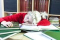 Tired blonde student woman sleeping on table at home Royalty Free Stock Photo