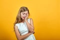 Tired blonde young woman keeping hand on face, doing sleep gesture Royalty Free Stock Photo