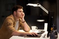 Tired or bored man working late at night office Royalty Free Stock Photo