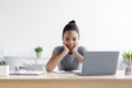 Tired bored pensive young black girl resting, thinking over task at laptop, studying at home interior Royalty Free Stock Photo