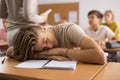 Tired bored teenage schoolboy sleeping Royalty Free Stock Photo