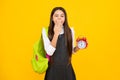 Tired and bored teenager girl. Back to school. Teenage school girl with bag hold clock alarm, time to learn. Schoolgirl Royalty Free Stock Photo