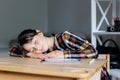 Schoolgirl is sleeping while doing homework, tired from studying, exhausted Royalty Free Stock Photo