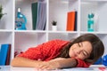 Tired and bored teenager school girl. Schoolgirl is sleeping while doing homework, tired from studying, exhausted. Royalty Free Stock Photo