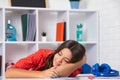 Tired and bored teenager school girl. Schoolgirl is sleeping while doing homework, tired from studying, exhausted. Royalty Free Stock Photo