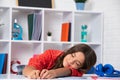 Tired and bored teenager school girl. Schoolgirl is sleeping while doing homework, tired from studying, exhausted. Royalty Free Stock Photo