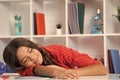 Tired and bored teenager school girl. Schoolgirl is sleeping while doing homework, tired from studying, exhausted. Royalty Free Stock Photo