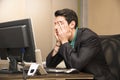 Tired bored young businessman in office Royalty Free Stock Photo