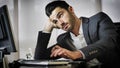 Tired bored young businessman in office Royalty Free Stock Photo