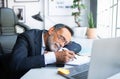 Tired boring exhausted lazy old caucasian man in suit resting, sleeping at table in office interior